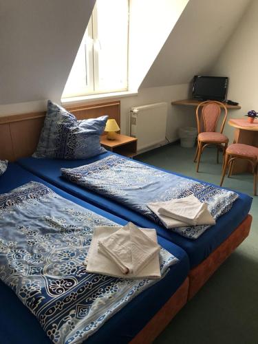 a bedroom with a bed with towels on it at Pension in Warin