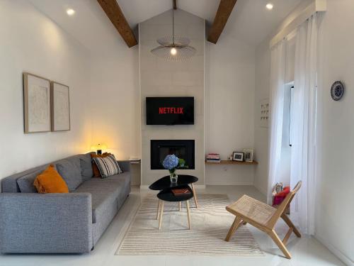 a living room with a couch and a fireplace at Casa Amélia in Feteira Grande