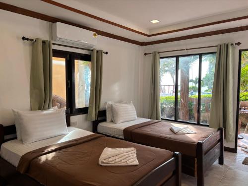 Ένα ή περισσότερα κρεβάτια σε δωμάτιο στο Friendly Resort