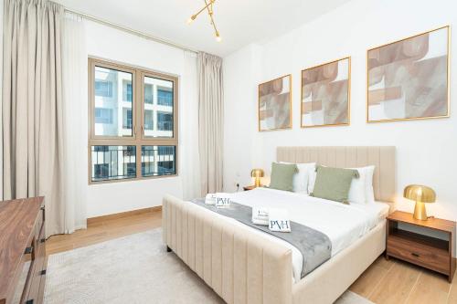 a bedroom with a large bed and two windows at PVH - Breezy 1BR with Partial Sea View - La Sirene in Dubai