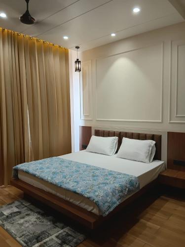 a bed with two pillows at Hotel Shrivardhan in Sūratgarh