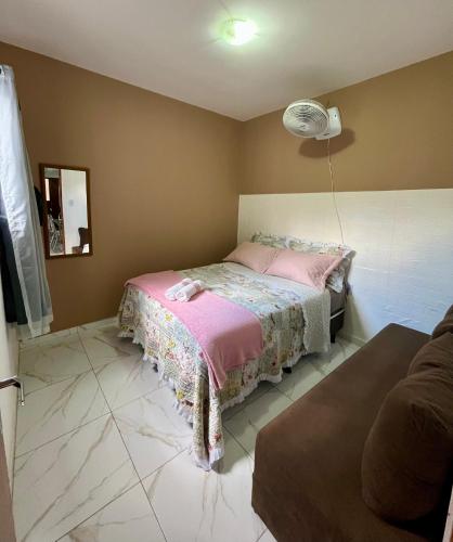 a bedroom with a bed with a pink blanket at Serraruna House no centro histórico in Araruna