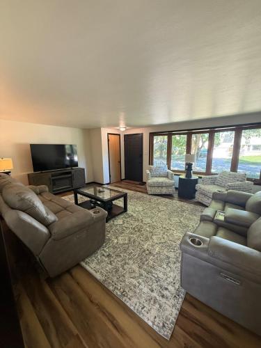 a living room with two couches and a television at Three Bedroom Ranch walking distance to Lambeau in Green Bay