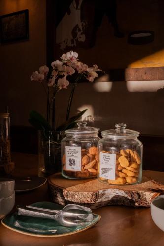 a table with two jars of cookies and a plate at Agriturismo Giacomino in Gera Lario