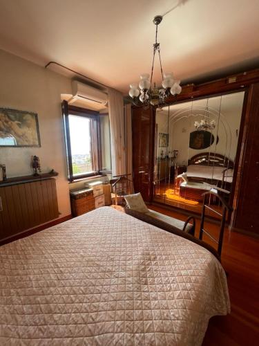 a bedroom with a large bed and a mirror at Le Pergole in Trieste