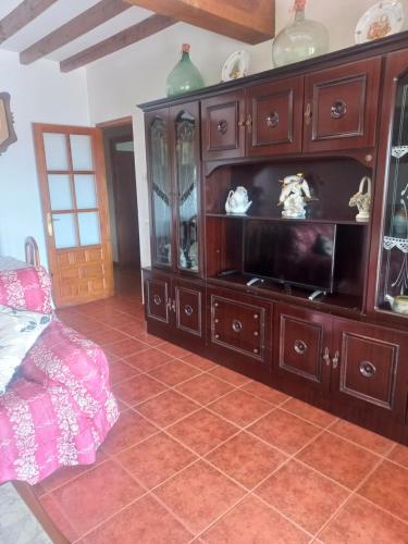 a large wooden entertainment center in a room at Casa Cordovilla in Sequeros