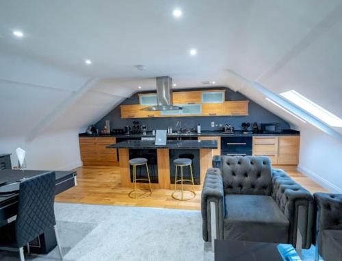 a kitchen with a couch and a table in a room at Spacious Two Bed Central Sunniside Penthouse Apartment in Sunderland