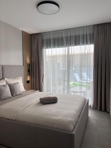 a bedroom with a large bed with a large window at Premium Alicante in Gran Alacant