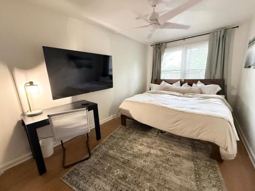 a bedroom with a bed and a tv and a rug at The Float House at Buckeye Lake - Hot Tub - Patio - Privacy in Thornville