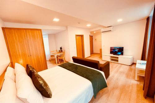 a hotel room with a bed and a television at Living Funchal X in Funchal