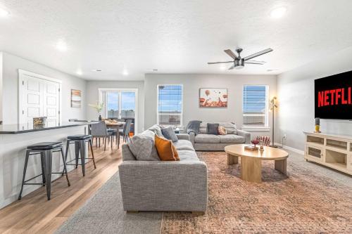 a living room with a couch and a table at Spacious 5BR - Gamer Room - Hot Tub & Basketball in Star