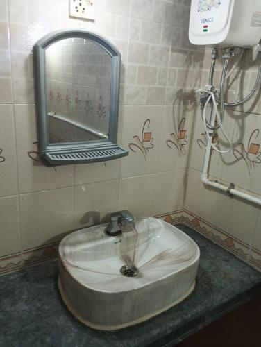 a sink in a bathroom with a mirror at Peace Villa with pool in Murud