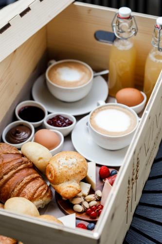 a wooden box filled with different types of breakfast foods at Vivi Suites & Spa - Boutique Guest House Molveno in Molveno