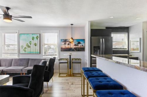 a kitchen and living room with blue chairs and a counter at Mini Boutique Hotel - THE ELLA by EVRH in Daytona Beach