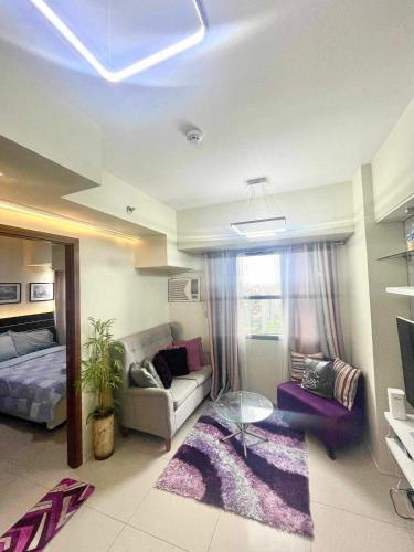 a living room with a couch and a table at Horizons 101 Condominium in Cebu City