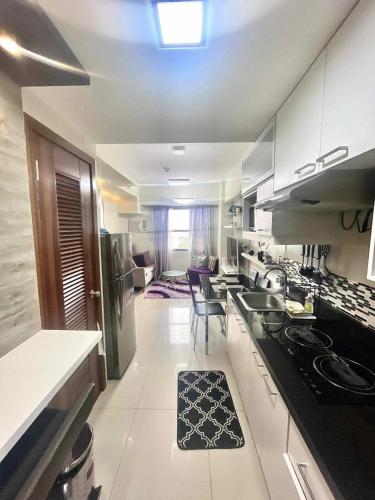 a kitchen with a sink and a counter top at Horizons 101 Condominium in Cebu City