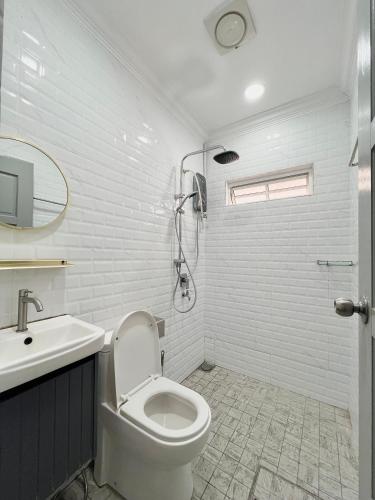 a bathroom with a toilet and a sink and a shower at Roomah Puteh in Shah Alam