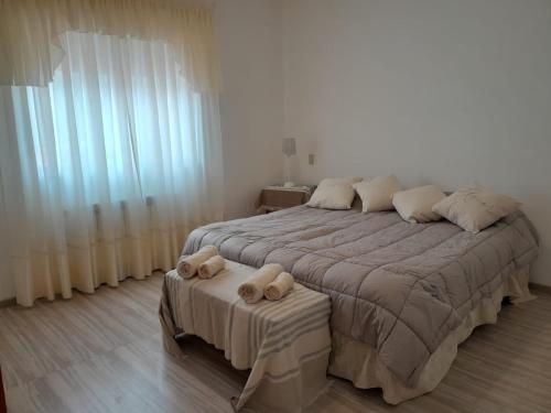 a bedroom with a large bed with two pillows at Espacio Comodoro P in Comodoro Rivadavia