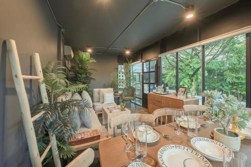a dining room with a table and some plants at SunMui Pool Villa - 7 Bedrooms - Old town in Chiang Mai