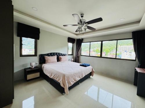 a bedroom with a bed and a ceiling fan at Patong Elite Condo Nanai, Patong, Phuket in Patong Beach