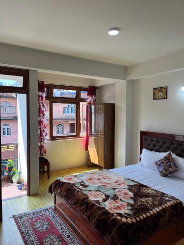 a bedroom with a large bed and a window at Shenga Homestay in Ravangla