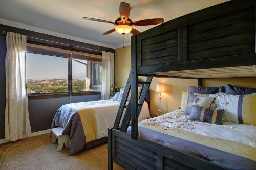 een slaapkamer met een groot bed en een plafondventilator bij A Villa with extraordinary views in Solvang