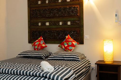 two pillows on a bed in a room at O'Reilly's Bungalow in Negombo