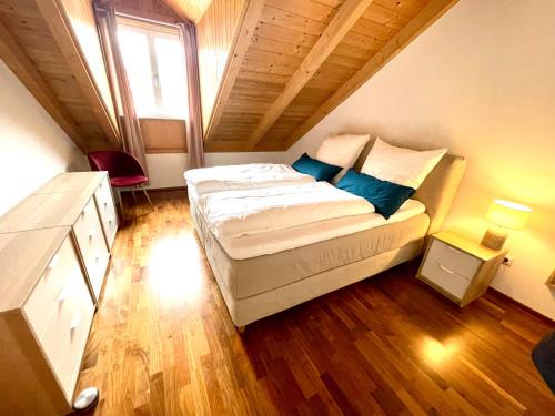 a bedroom with a large bed in a attic at Loftwohnung Sankt Wolfgang in Sankt Wolfgang