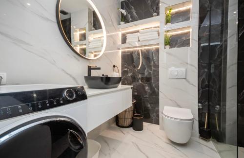 a bathroom with a sink and a toilet and a mirror at Apartments Duje in Dugi Rat