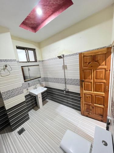 a bathroom with a sink and a shower and a toilet at BHURBAN MOUNTAIN VIEW APARTMENTs in Murree