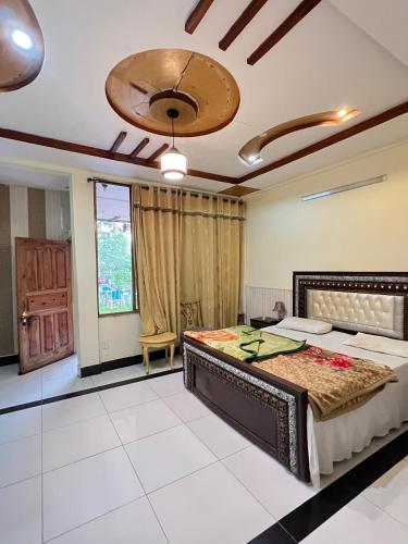 a bedroom with a large bed in a room at BHURBAN MOUNTAIN VIEW APARTMENTs in Murree