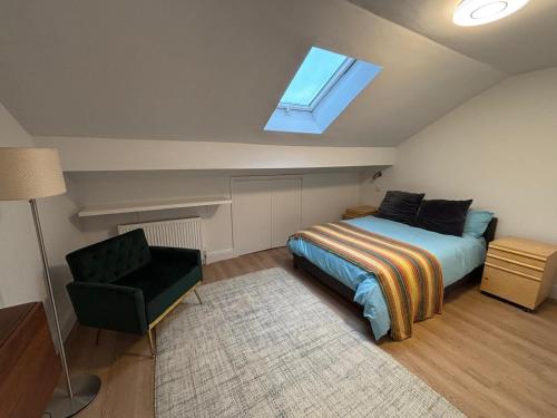 a bedroom with a bed and a window and a chair at Bedford Guesthouse in Liverpool