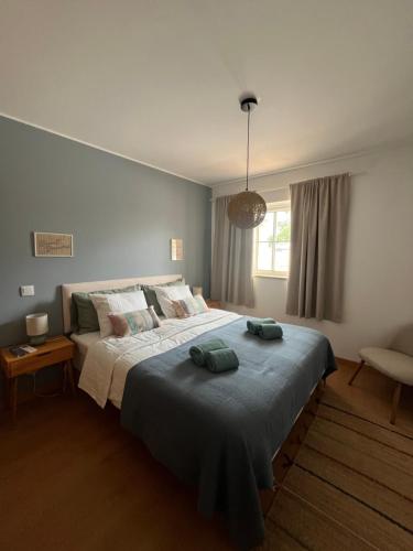 a bedroom with a bed with two towels on it at Cabanas De Miramar in Tavira