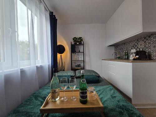 a room with two bottles and glasses on a table at Leśny Zakątek I Małe Bieszczady w Rzeszowie I grill sauna Starowiejska 6 Rzeszów in Rzeszów