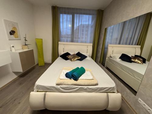 a bedroom with two beds and a mirror at Bob Residence- Chic Penthouse in Cluj-Napoca