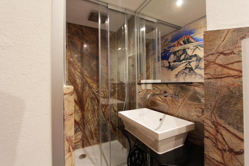 a bathroom with a sink and a shower at Haus am Rain in Partenen