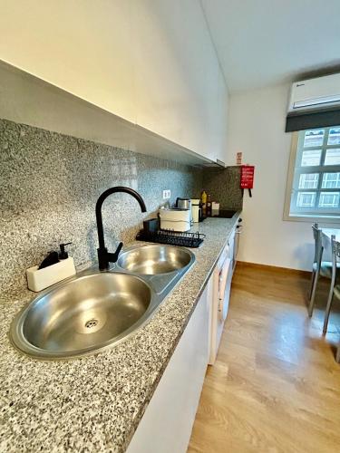 a kitchen with a sink and a counter top at Aquae Flaviae Urban Stay - Charm in Chaves