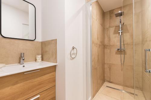 a bathroom with a sink and a shower at Zest Boheme Villeurbanne in Saint-Priest