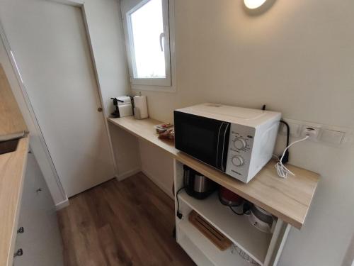 una piccola cucina con forno a microonde su un bancone di Tiny House Base Camp Granada Camping a Dúrcal