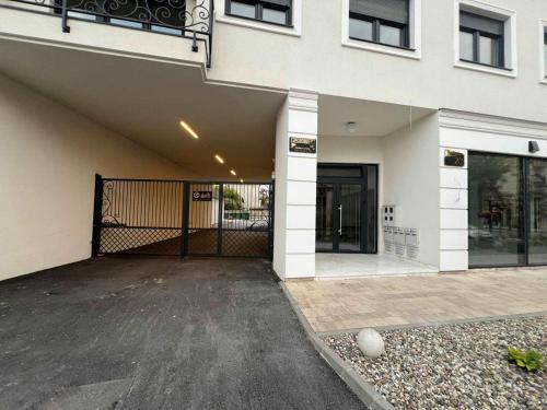 a building with a gate and a driveway at Apartment VIP in Subotica
