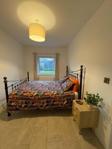 a bedroom with a bed and a window at Joy's River Lodge in Killorglin