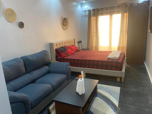 a living room with a couch and a bed at teranga in Dakar