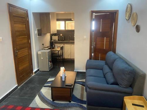 a living room with a blue couch and a table at teranga in Dakar