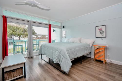 a bedroom with a bed and a large window at Park Place Unit 129 in Cedar Key
