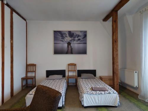 a room with two beds and a picture on the wall at Centrum Lwowska in Warsaw