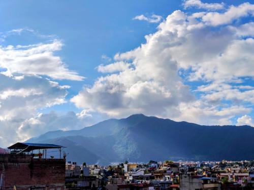 Una vista de una ciudad con una montaña al fondo. en Nepal Blissful Nest And Family Home, en Katmandú