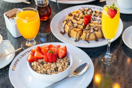 a table with two plates of food and two glasses of orange juice at Catalina Hotel & Beach Club in Miami Beach