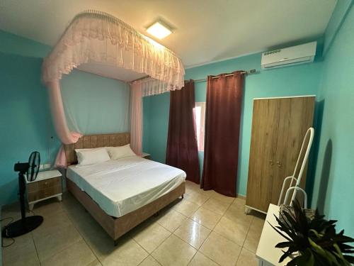 a bedroom with a bed with a canopy at Océan Voyages Mitsamihouli in Mitsamiouli