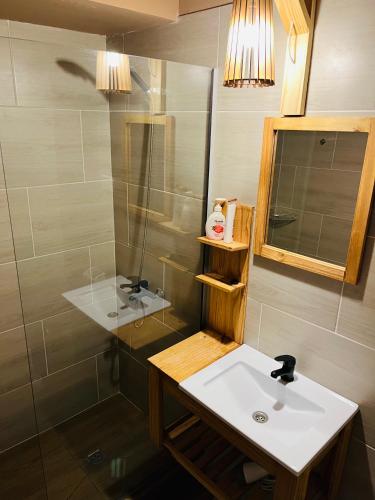 a bathroom with a sink and a shower at Hotel Koi Mahik in El Calafate