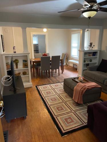 a living room with a couch and a table at Private downtown cottage in Indianapolis